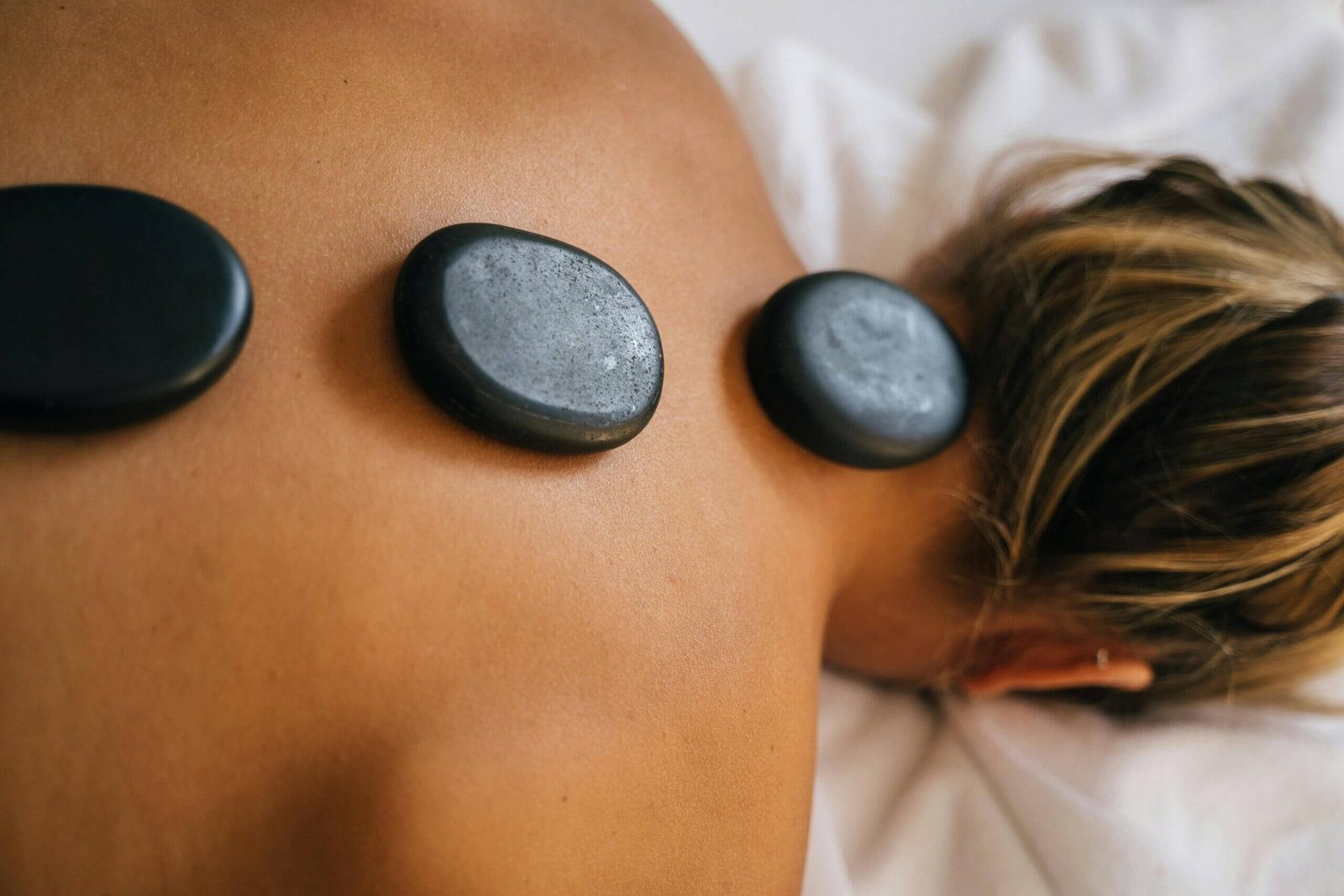 Relaxing hot stone massage therapy using heated stones
